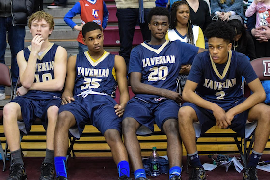 Members of the Xaverian Clippers — Bard Featherston, Brandon Leftwich, Zack Bruno and Khalil Rhodes — look on in disappointment as they watch Christ the King hoist the CHSAA championship trophy for the third time in three years. Eagle photo by Rob Abruzzese