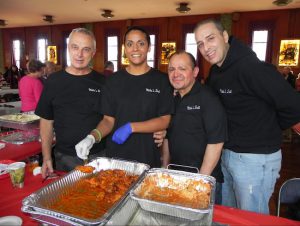 George LoParnos (left) owner of Mike’s Deli, and his crew brought trays of lasagna, mac & cheese, Norwegian meatballs and other delicious treats to the fundraiser. Pictured with LoParnos are Kristalina Nunez, Chef Alex Alvarado and Adam LoParnos (left to right). Eagle photo by Paula Katinas