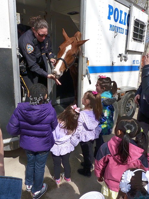Children of employees at the city’s Office of Emergency Management got to pet horses and blast an audience siren on Thursday for Take Our Daughters and Sons to Work Day.  Photo by Mary Frost