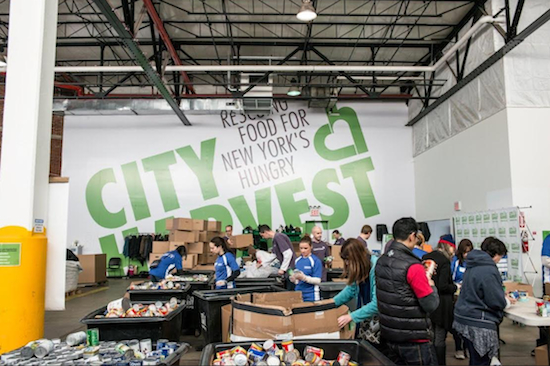 City Harvest volunteers sort canned and nonperishable goods at a previous food drive. Photo courtesy of City Harvest