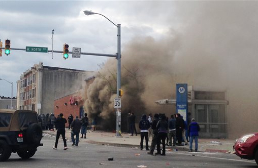 Smoke billows from a CVS Pharmacy store in Baltimore on Monday. Demonstrators clashed with police after the funeral of Freddie Gray. Gray died from spinal injuries about a week after he was arrested and transported in a Baltimore Police Department van. AP Photo/Juliet Linderman