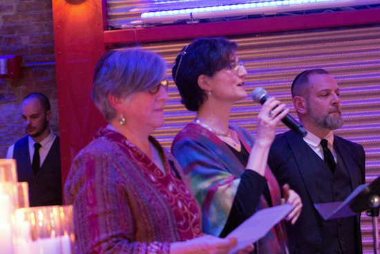 Rabbi Ellen Lippmann and Cantor Lisa Segal of Congregation Kolot Chayeinu join with Amichai Lau-Lavie of Lab/Shul to light the candles that symbolize the evening’s three faith observances.  Eagle photo by Francesca Norsen Tate