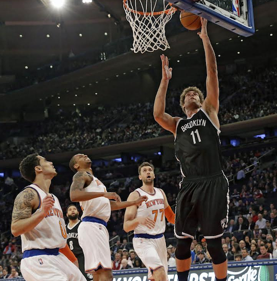 Brooklyn’s Dark Knight, Brook Lopez, lifted the Nets to a dramatic 100-98 victory over the East River rival Knicks Wednesday night at Madison Square Garden. AP photo