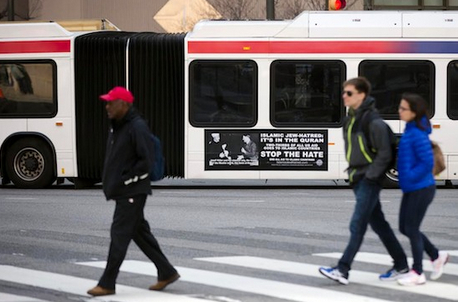 Shown is an ad from the pro-Israel American Freedom Defense Initiative on a Southeastern Pennsylvania Transportation Authority bus featuring a 1941 photograph of Hitler and supporter Hajj Amin al-Husseini in Philadelphia. New York is following in the footsteps of cities including Los Angeles, Chicago and Philadelphia, which have already banned political ads on public transit, the agency said. AP Photo/Matt Rourke