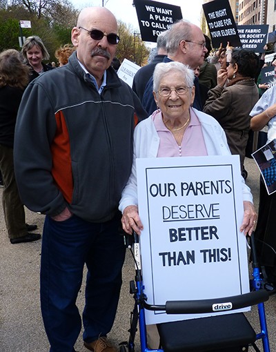 Ruth Willig, 90, with her son Bruce, at a protest against the residents’ eviction from the Prospect Park Residence in April 2014. Photo by Mary Frost