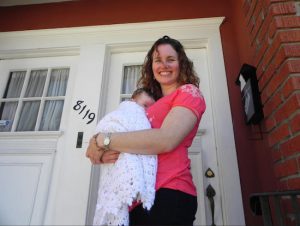 Andrea Stockton, holding her two-month-old daughter, is a stay-at-home mother of three who says the city’s one-size-fits-all universal pre-kindergarten program isn’t the right fit for everyone. Eagle photo by Paula Katinas
