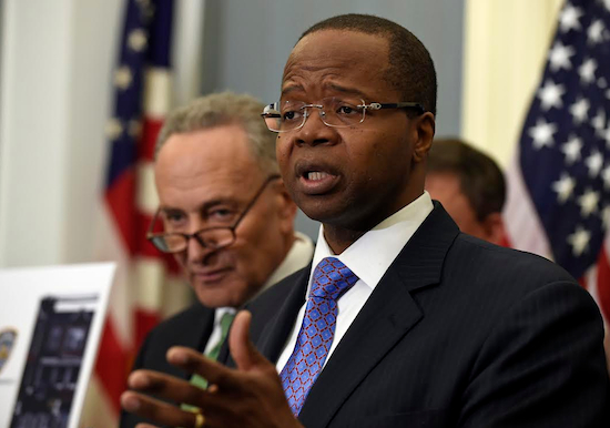 Brooklyn District Attorney Ken Thompson (right) and U.S. Sen. Charles Schumer (left) urged the TSA to implement a national requirement that all airports physically screen airline and airport employees after a gun-smuggling event in December 2014. AP Photo/Susan Walsh