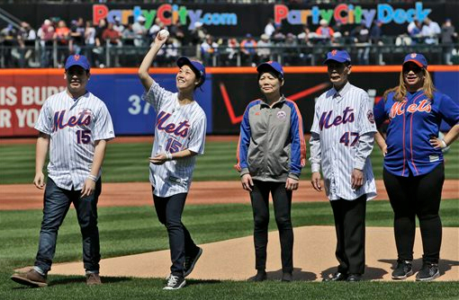 Members of the family of New York City Police officers Wenjian Liu and Rafael Ramos throw out the ceremonial first pitches before the Mets opening day baseball game against the Philadelphia Phillies in New York on Monday. Both officers, posthumously promoted to detectives, were shot in Dec. 2014, while on duty AP Photo/Kathy Willens