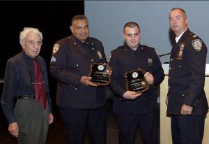 Community Council President Leslie Lewis (left) and Capt. Sergio Centa (right) presented Sgt. David Cheesewright (second from left), Officer John Uske (second from right) and Lt. Frank Jurs (not pictured) with the Cop of the Month Award. Photo courtesy of Steve Neiman.