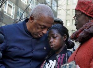 State Assemblymember-elect Charles Barron, left, and his wife, City Councilwoman Inez Barron, flank Melissa Butler, Akai Gurley's girlfriend, during a news conference in Brooklyn. AP Photo/Richard Drew