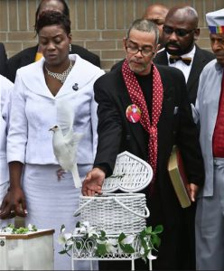 In this June, 2014 file photo, Aricka McClinton, left, and Nicholas Avitto, center, release white doves in tribute to their son Prince Joshua Avitto, after his funeral in Brooklyn. McClinton sued the city on Thursday, saying officials let blatant security risks linger before the attack on her son and a 7-year-old friend. Prince and his friend, Mikayla Capers, were attacked in a building at the Boulevard Houses complex in Brooklyn in June. AP Photo/Bebeto Matthews, File