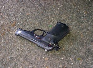 This photo provided by the NYPD shows a gun that was in the possession of a man who was shot to death by police in Brooklyn on Tuesday. The man was suspected of killing his ex-girlfriend earlier in the morning outside the Resorts World Casino in Queens at around 2:30 a.m. before fleeing and texting death threats to a man who was with the woman who was shot. Authorities say the man was killed in a shootout at 6 a.m. NYPD via AP
