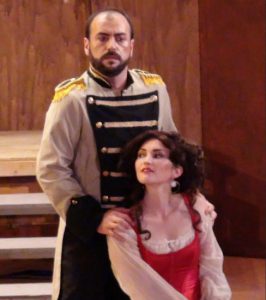 Don Jose (Paolo Buffagni, standing) is captivated by Carmen (Augusta Caso, seated). Photos by Phyllis Olsen