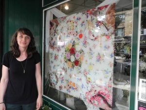 Margaux Walter said the goal of her work, which is on display in the front window of Enchanted Florist at7515 Fifth Ave., is to encourage the viewer to notice the beauty of flowers. Eagle photos by Paula Katinas