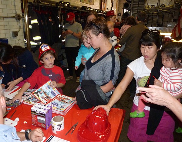 The firehouse handed out coloring books, fire safety tips and snacks to the crowd. Photo by Mary Frost