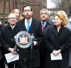 State Sen. Daniel Squadron (at podium) and Assemblymember Jo Anne Simon (right) sponsored the LICH Act to prevent another chaotic hospital closing. Shown left: City Comptroller Scott Stringer. Photo by Mary Frost