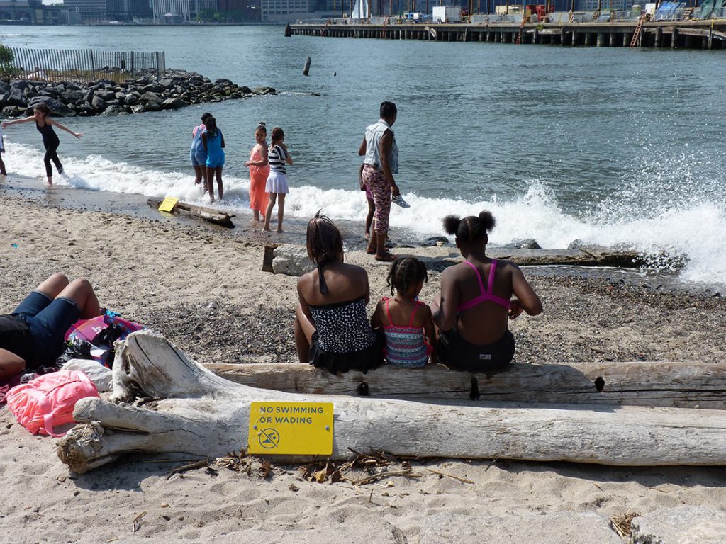 The “No swimming or wading” signs were blithely ignored as visitors dipped their toes into the East River. 