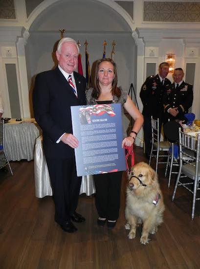 Katherine Ragazzino, with her faithful service dog, Daisy, accepts an award from state Sen. Marty Golden at the breakfast. Eagle photos by Paula Katinas