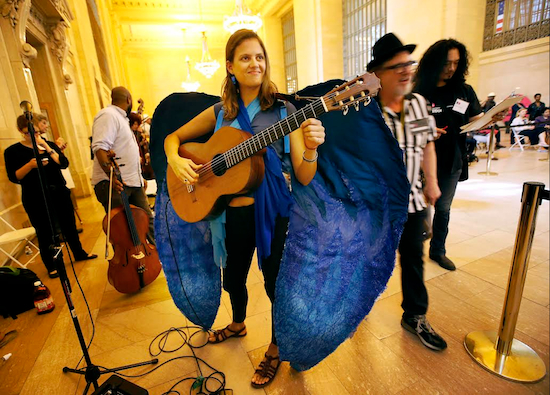 Potential subway musician from Brooklyn Jacinta Clusellas, "El Pajaro Azul, " or Bluebird, warms up before auditioning for judges in Grand Central Terminal's Vanderbilt Hall in New York, Tuesday, May 19, 2015. About 70 musicians and others showed up Tuesday at the station to vie for official permission to set up their acts on an underground platform or walkway.  AP Photo/Kathy Willens