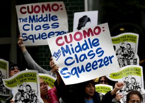 People hold signs during a demonstration in front of New York Governor Andrew Cuomo's offices on May 6. New York Mayor Bill de Blasio wants state lawmakers to expand tenant protections for the city's 1 million rent-regulated apartments. AP Photo/Seth Wenig