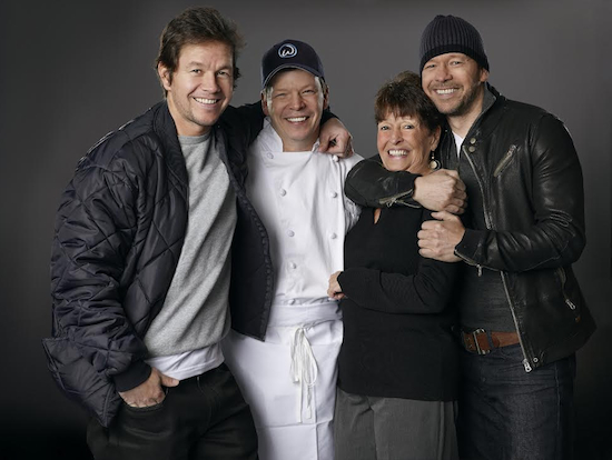 Siblings Mark, Paul and Donnie Wahlberg, (left to right) along with their mother Alma, are getting ready to open their new restaurant Wahlburgers, on Stillwell Avenue. Photo by Zach Dilgard