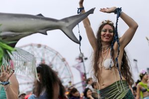 A participant in the 33rd annual Mermaid Parade marches on the boardwalk Saturday in Coney Island.  AP Photos/Mary Altaffer