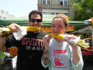 Michael Arkous and Anita Mercado bite into ears of corn, one of the many delicious foods available at the festival. Eagle photos by Paula Katinas