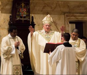 Bishop Nicholas DiMarzio gives the blessing at the conclusion of Mass. Standing with him are Deacon Yvon Aurelien and Deacon Jose Enriquez, natives of Haiti and the Dominican Republic, respectively. Eagle photos by Francesca Norsen Tate