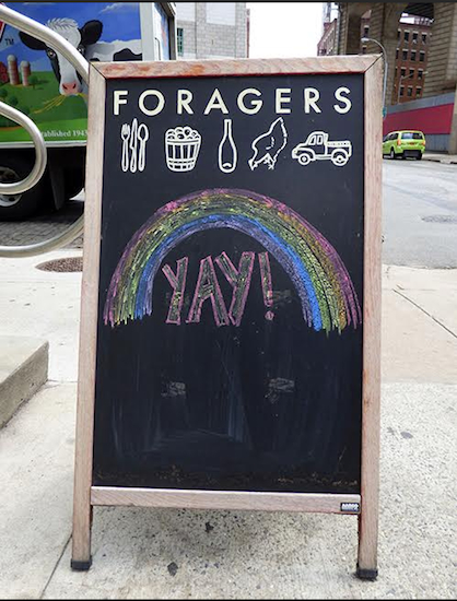 The sign outside of Foragers Market on Front Street in DUMBO celebrated Friday's Supreme Court ruling. Photo by Mary Frost
