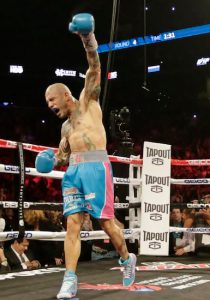 Miguel Cotto lifts his left arm in triumph after using it to nearly knock challenger Daniel Geale out of the ring Saturday night at Downtown’s Barclays Center. AP photo