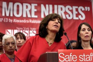 President Judy Sheridan-Gonzalez, left, and Executive Director Jill Furillo, right, of the New York State Nurses Association, address a news conference on Wednesday. The union representing more than 18,000 registered nurses at 14 of New York City's private hospitals says members have voted to authorize a strike if contract negotiations aren't carried out in good faith. AP Photo/Richard Drew