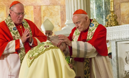 Theodore Cardinal McCarrick, archbishop emeritus of the Diocese of Washington, lays hands on new Auxiliary Bishop James Massa. Timothy Cardinal Dolan, archbishop of the Diocese of New York (at left) was also one of the co-consecrators. Eagle photos by Francesca N. Tate