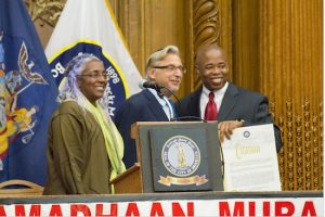 Mark Meyer Appel (center), co-founder of The Bridge Project, receives a citation from Brooklyn Borough President Eric Adams at the July 9 Iftar. Standing with them (at left) is Dr. Khadijah Abdul-Matin, the evening’s master of ceremonies. Brooklyn Eagle Photo by Francesca N. Tate