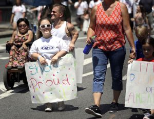 Madison Ehler marches in the inaugural Disability Pride Parade on Sunday. The parade grand marshal was former U.S. Sen. Tom Harkin, the Iowa Democrat who 25 years ago sponsored the Americans With Disabilities Act.
