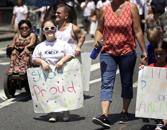 Madison Ehler marches in the inaugural Disability Pride Parade on Sunday. The parade grand marshal was former U.S. Sen. Tom Harkin, the Iowa Democrat who 25 years ago sponsored the Americans With Disabilities Act.