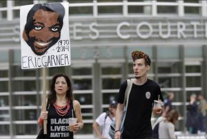 Demonstrators M.J. Williams, left, and Connor Hicks take part in a rally on Saturday outside the federal courthouse in Brooklyn to demand action in the fatal chokehold death of Eric Garner by a white police officer. AP Photos/Mary Altaffer