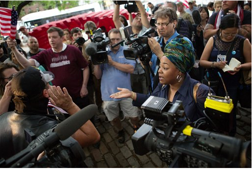 Activists from opposing sides argue while surrounded by media cameras ahead of a planned flag-burning event at Fort Greene Park on Wednesday. AP Photos/Kevin Hagen