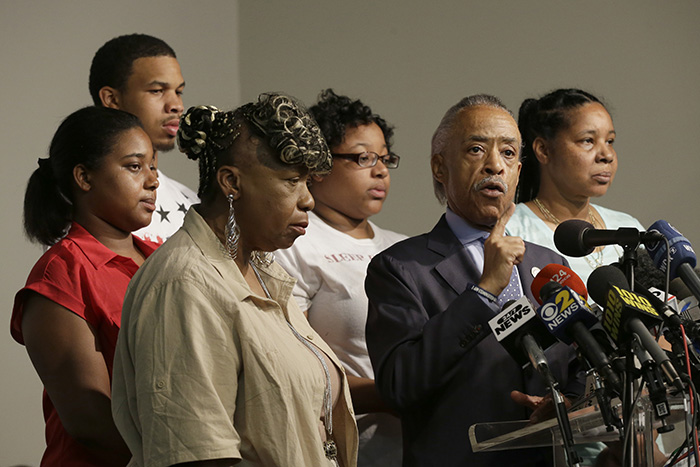 The Rev. Al Sharpton, second from right, is joined by Eric Garner's mother Gwen Carr, left, daughter Erica Garner, second from left, son Eric Garner, third from left, daughter Emerald Snipes, third from right, and wife Esaw Snipes.