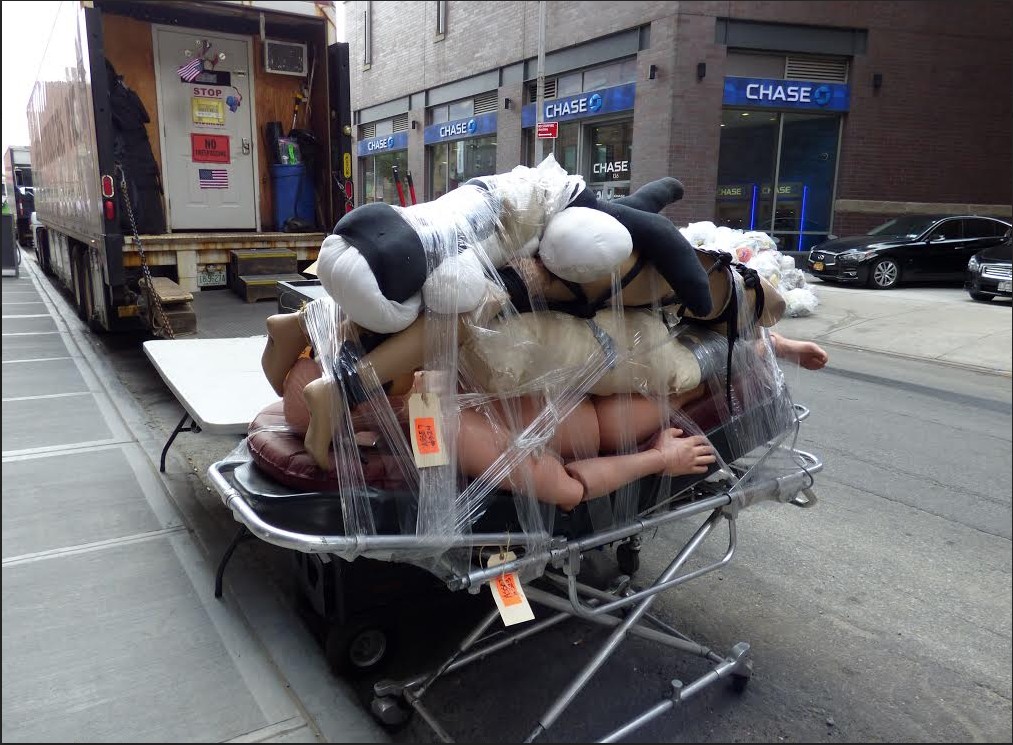 A cart full of bodies sits on Front Street. Photo by Mary Frost