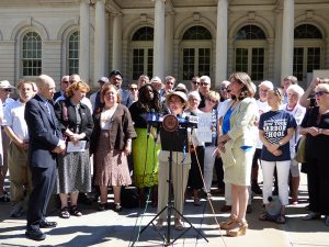 Community groups and elected officials rallied on the steps of City Hall on Thursday in support of a City Council bill that would ban noisy sightseeing helicopters. Shown: Councilmember Margaret Chin at podium. Councilmember Helen K. Rosenthal, one of the bill’s sponsors, stands third from right. Brooklyn Assemblymember Jo Anne Simon is standing third from left. Photo by Mary Frost