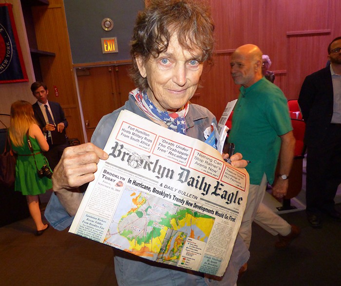 Patti Hagan holds a Brooklyn Eagle newspaper she has saved from September 16, 2005, featuring a story headlined "In Hurricane, Brooklyn's Trendy New Developments Would Go First." Photos by Mary Frost