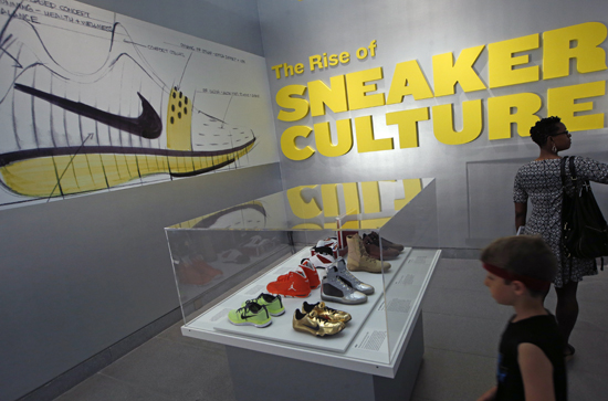 Spectators view unique athletic shoes at "Out of the Box: The Rise of Sneaker Culture" exhibit on display at the Brooklyn Museum on Wednesday.