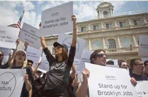 Uber drivers and supporters rally with signs during a press conference outside City Hall on June 30. AP Photo/Bebeto Matthews