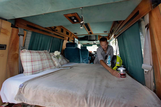 In this Aug. 3 photo, Jonathan Powley, who rents parked vehicles on Airbnb, prepares a 1995 Chevrolet conversion van, one of his offerings, in Queens. While parked vehicles make up only a fraction of the thousands of Airbnb listings in New York City, they provide an option for adventurous, budget-minded visitors seeking a place for far less than the $200-and-up most hotels charge. AP Photo/Richard Drew