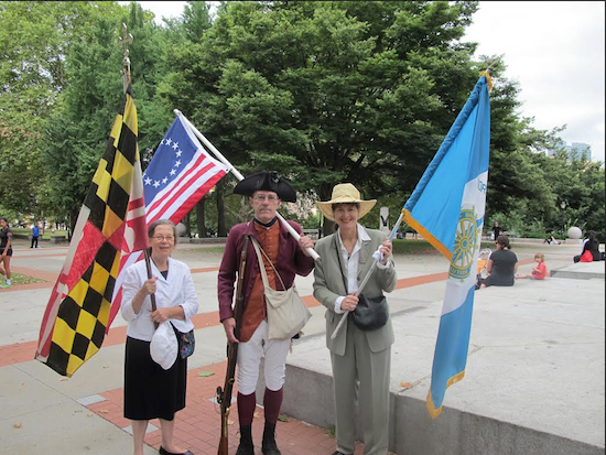 Jeanie Prall Wing, Norman Goben and Barbara Skinner dressed up and adorned flags for last year’s ceremony at the Prison Ship Martyrs Monument in Fort Greene Park. This year’s event will take place Saturday, Aug. 22 at 10 a.m. Eagle file photos by Matthew Taub