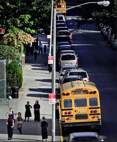 In this 2013 file photo, children gather on a sidewalk near school buses in Borough Park — a neighborhood that is home to many ultra-Orthodox Jewish families. Critics have charged for years that the rudimentary level of secular education at private yeshiva schools serving New York's Hasidic communities are deficient in teaching science, geography and math to grade school students. Now, for the first time, the city Department of Education is investigating more than three dozen of the schools. AP Photo/Bebeto