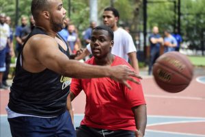 Intern Kareem Welch defends court officer Lenny Brackett during the annual basketball game between interns and court officers of the Kings County courts system. Eagle photos by Rob Abruzzese