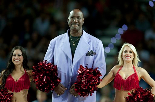 In this Oct. 2013, file photo, former Philadelphia's 76ers' Darryl Dawkins, center, receives a tribute before a match in Spain. Darryl Dawkins, whose backboard-shattering dunks earned him the moniker "Chocolate Thunder" and helped pave the way for breakaway rims, has died. He was 58. The Lehigh County, Pennsylvania coroner's office said Dawkins died Thursday morning at a hospital. AP Photo/Alvaro Barrientos, File