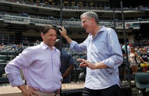 New York Mayor Bill de Blasio, right, talks with New York Mets chief operating officer before an interleague baseball game between the Mets and the Boston Red Sox on Sunday. AP Photo/Kathy Willens