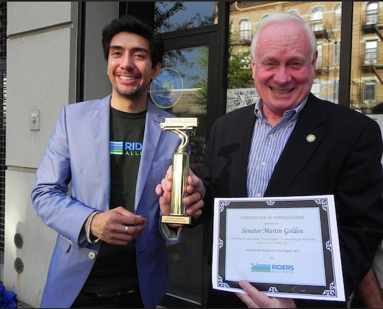 The trophy Riders Alliance Deputy Director Nick Sifuentes (left) gave to state Sen. Marty Golden had a bus on top. Eagle photo by Paula Katinas
